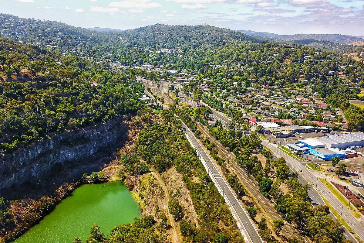 Aerial view over the quarry lake at Ferntree Gully with the Dandenong foothills behind it