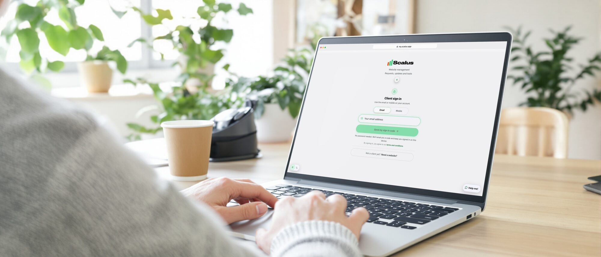Hands on a laptop with the Scalus App sign in page open at my.scalus.app