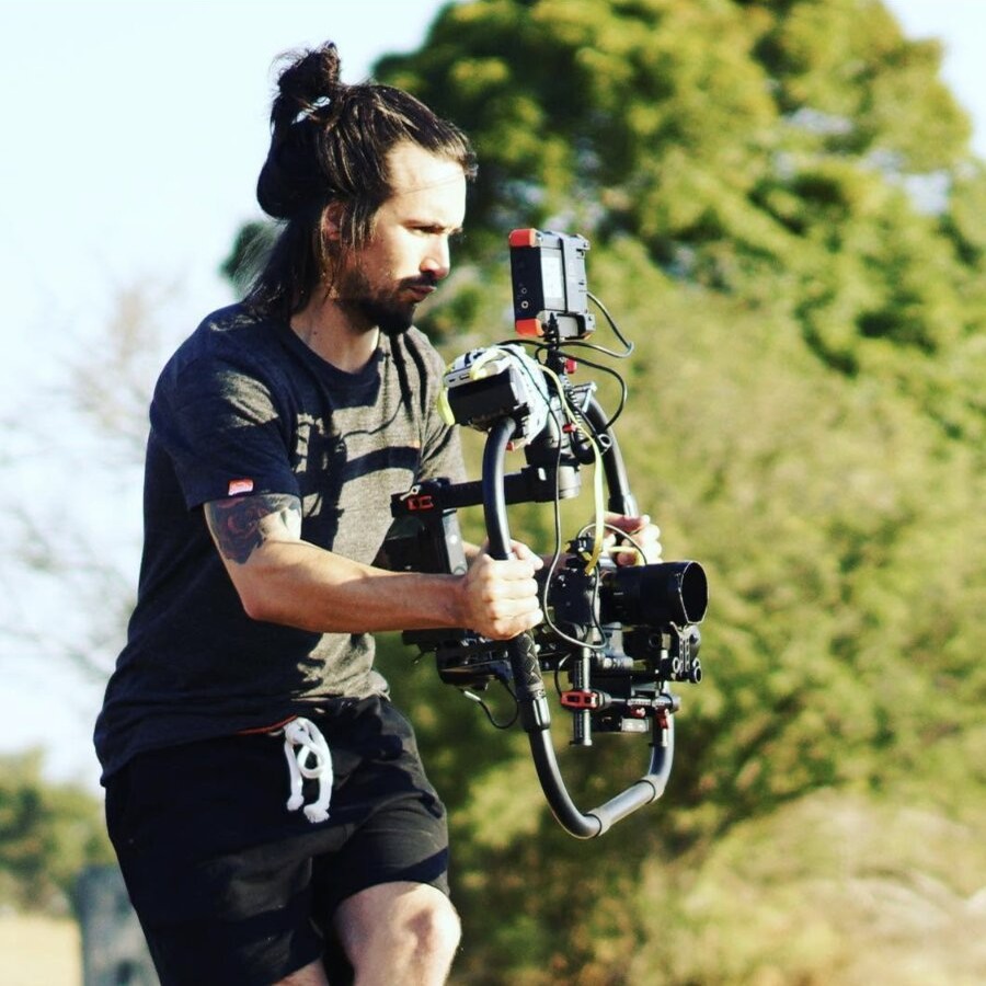 Tim McCartney running a camera on a gimbal outdoors